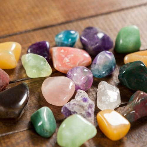 Colorful pebbles stones on wooden table